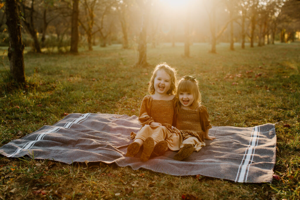 Siblings sharing a sweet moment during an outdoor family photography session.