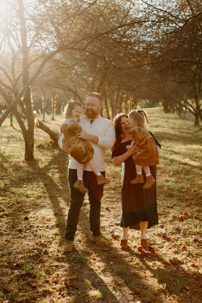 Family laughing together in the golden autumn light at Prairie Wolf Park.