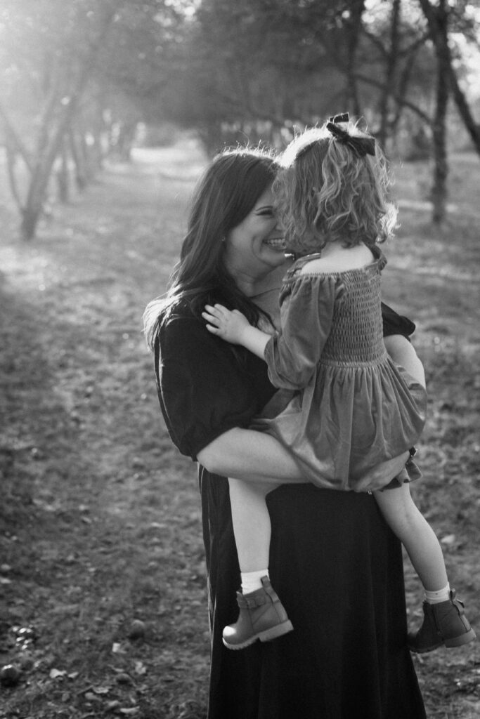 Mother hugging her child during a natural outdoor family photography session.