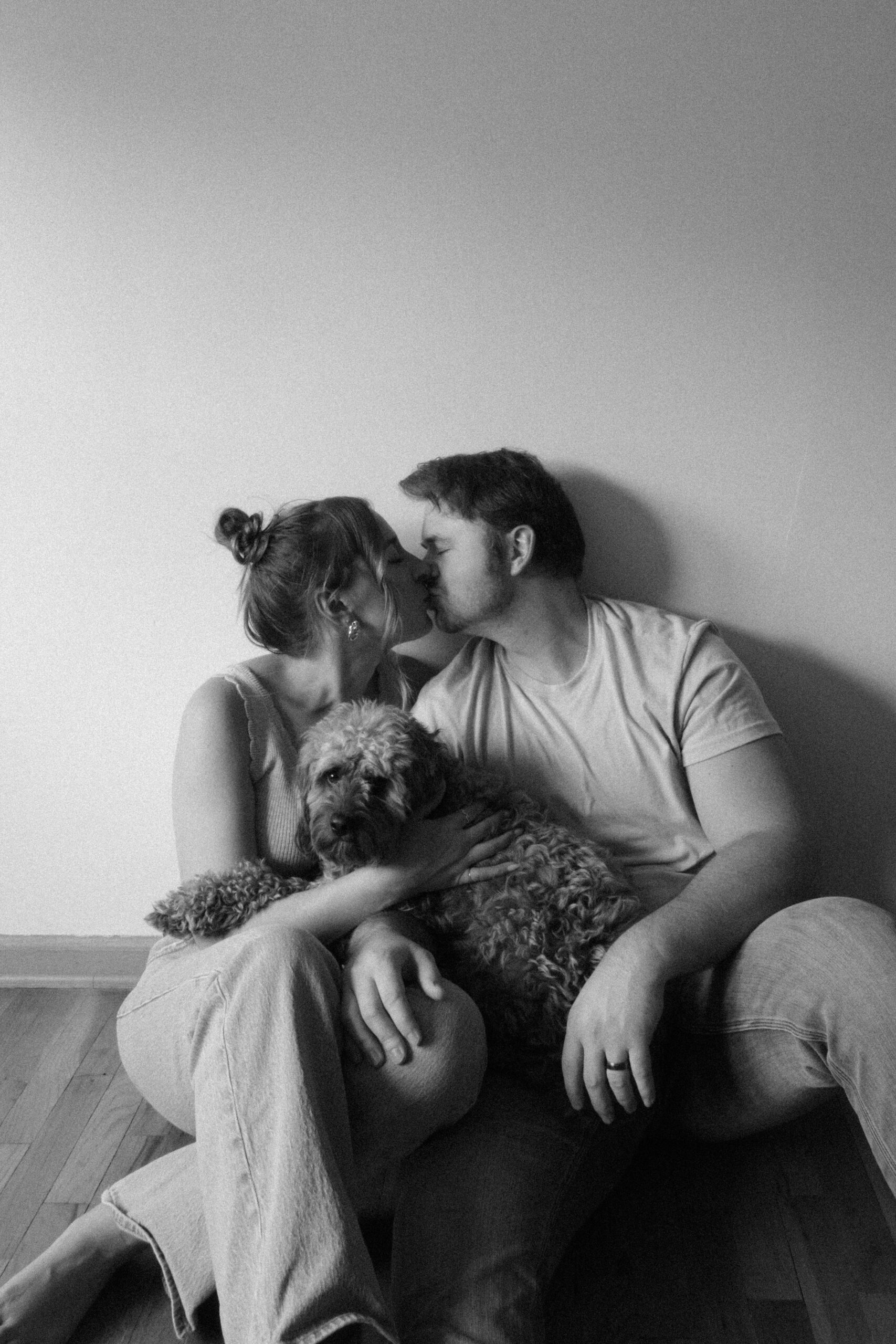 Precious Faith Photography owner with her husband and Cavapoo during a family portrait in West Michigan.
