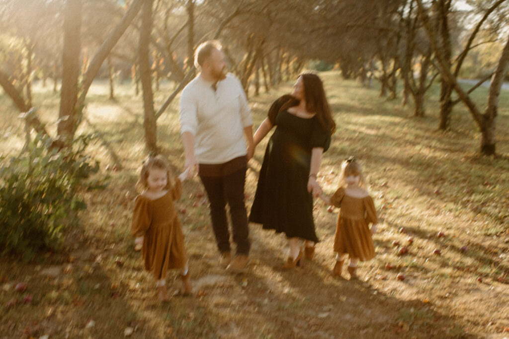 Family laughing together in the golden autumn light at Prairie Wolf Park.