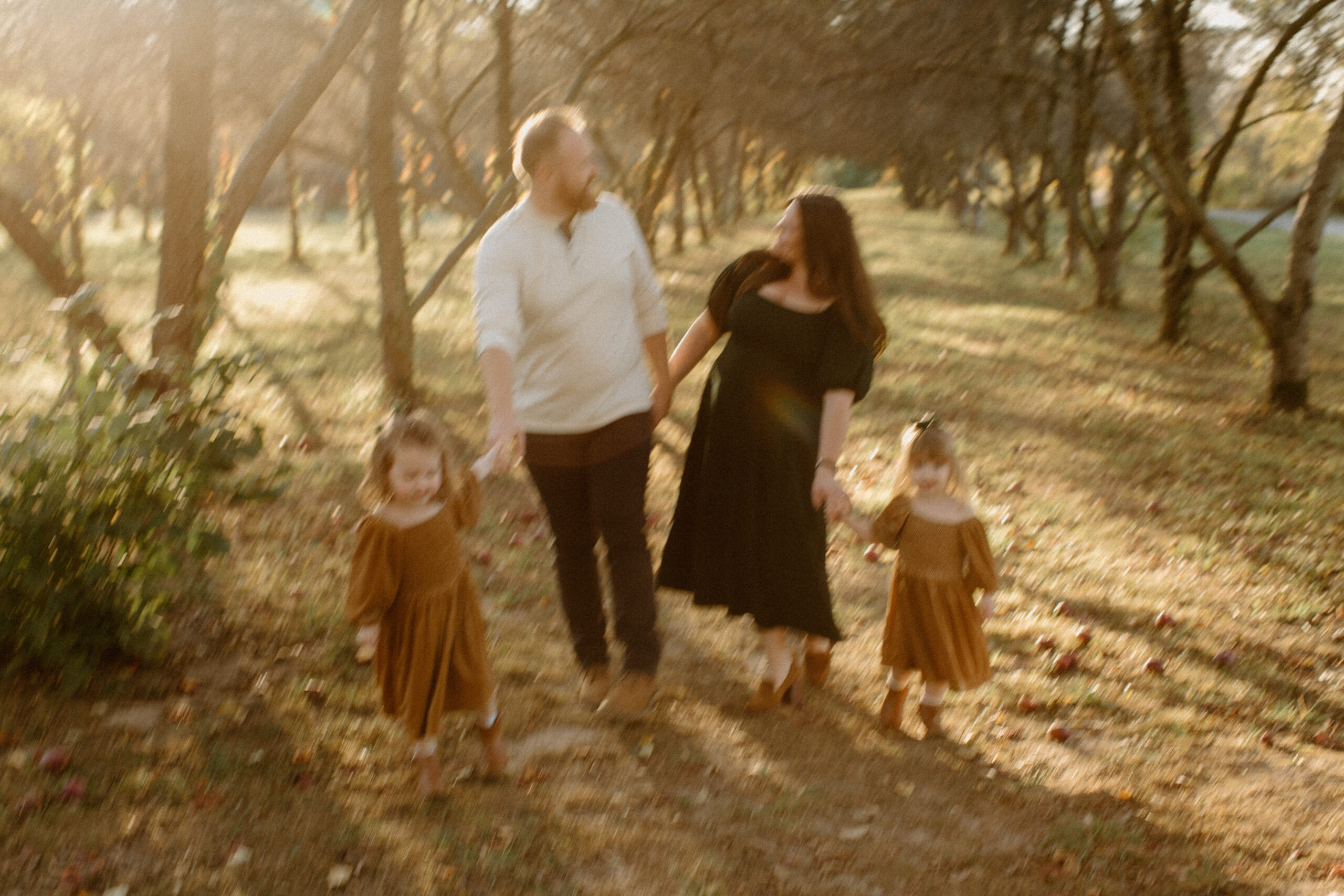 Family laughing together in the golden autumn light at Prairie Wolf Park.