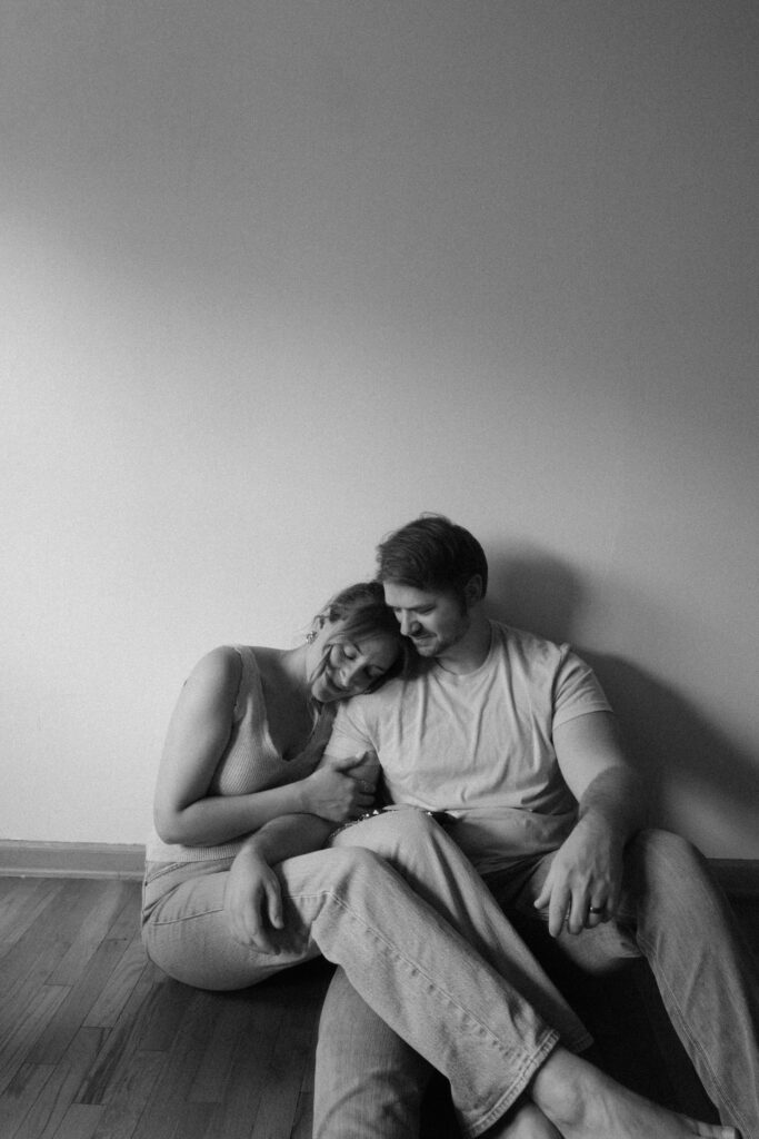 Precious and her husband smiling together during an indoor portrait session in Michigan.