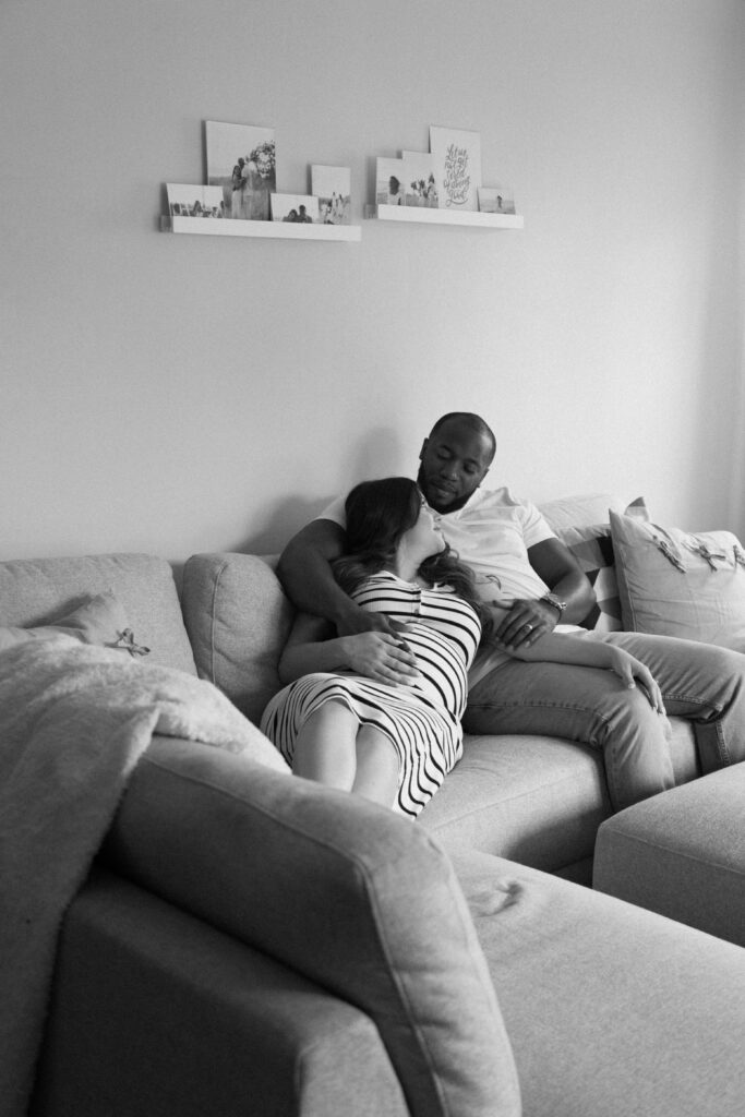 Parents-to-be smiling together while celebrating their growing family.