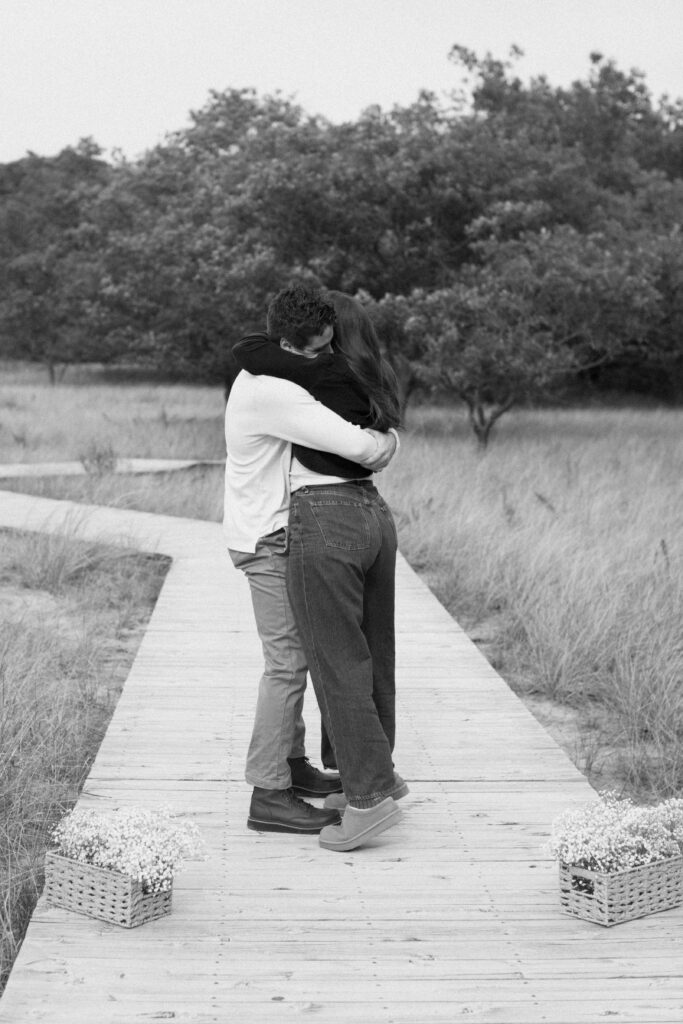 Couple embracing moments after a surprise proposal at Rosy Mound.